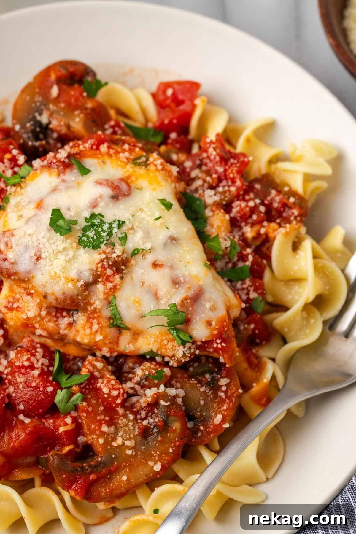 Rustic Marinara Chicken Bake 12 marinara chicken on plate with noodles and sauce, ready to eat.