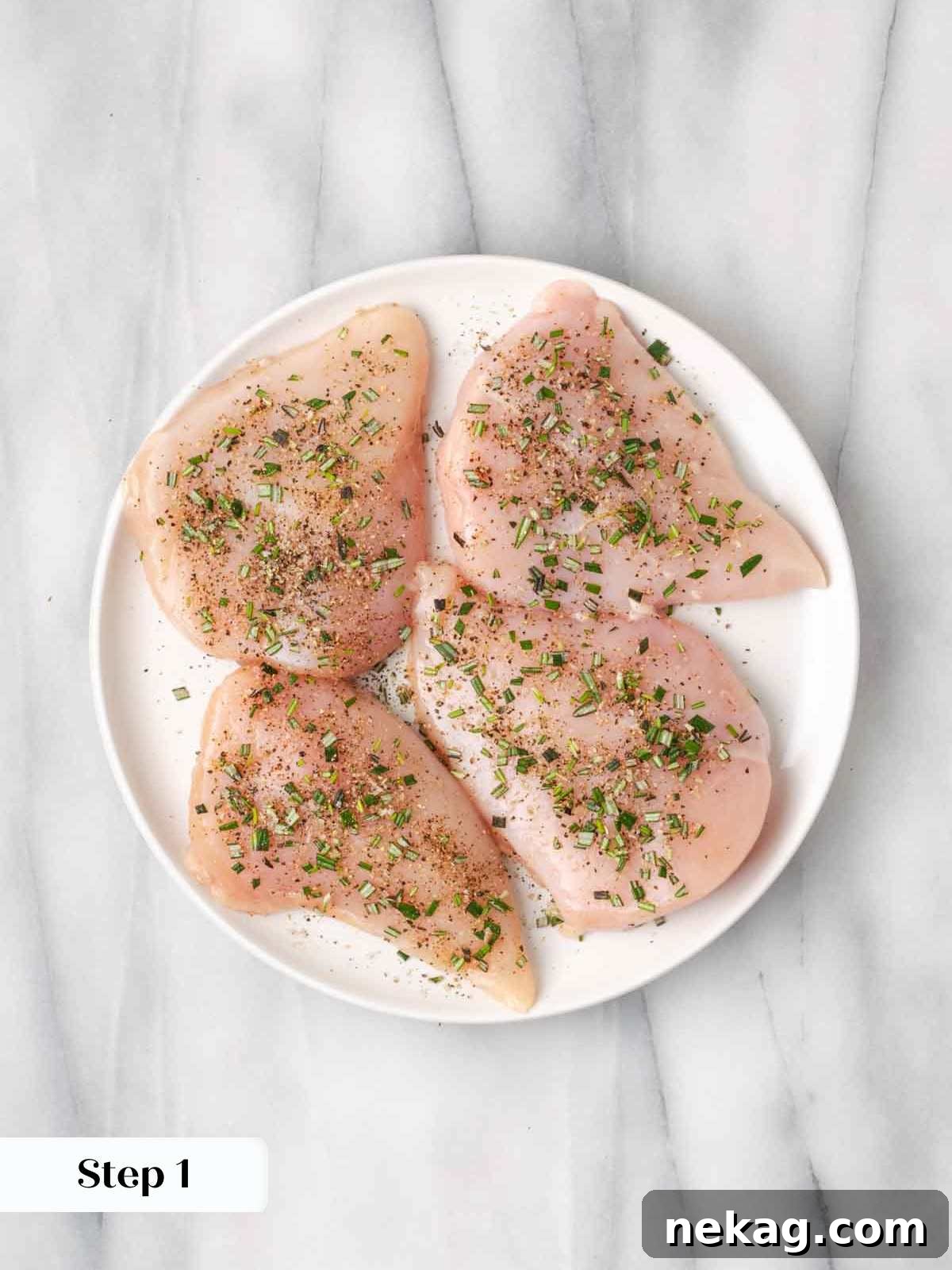 Rustic Marinara Chicken Bake 5 seasoned raw chicken breasts on a white plate, ready for searing.