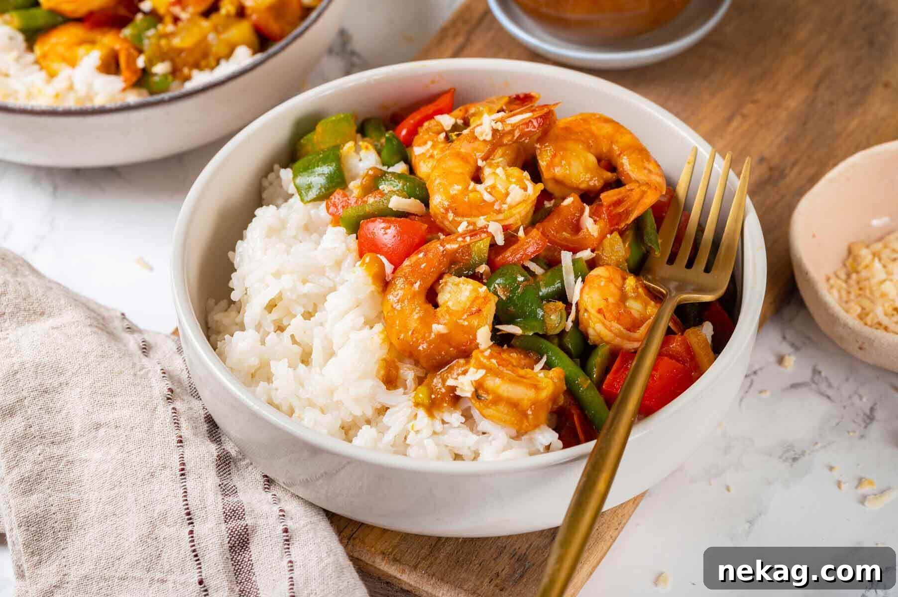 Two beautifully presented bowls of shrimp curry, garnished and ready to be enjoyed.