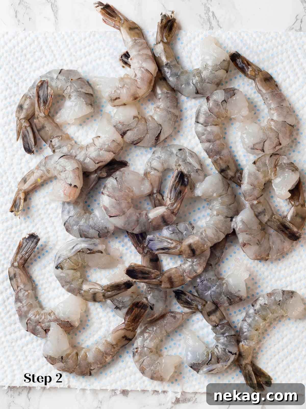 Fresh, uncooked shrimp being prepped for the curry, ready for cooking.