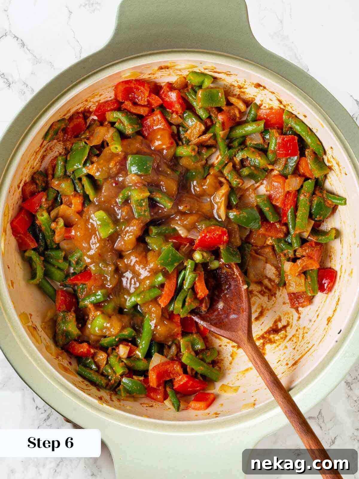 The simmering shrimp curry in a skillet, showcasing its rich texture and color.