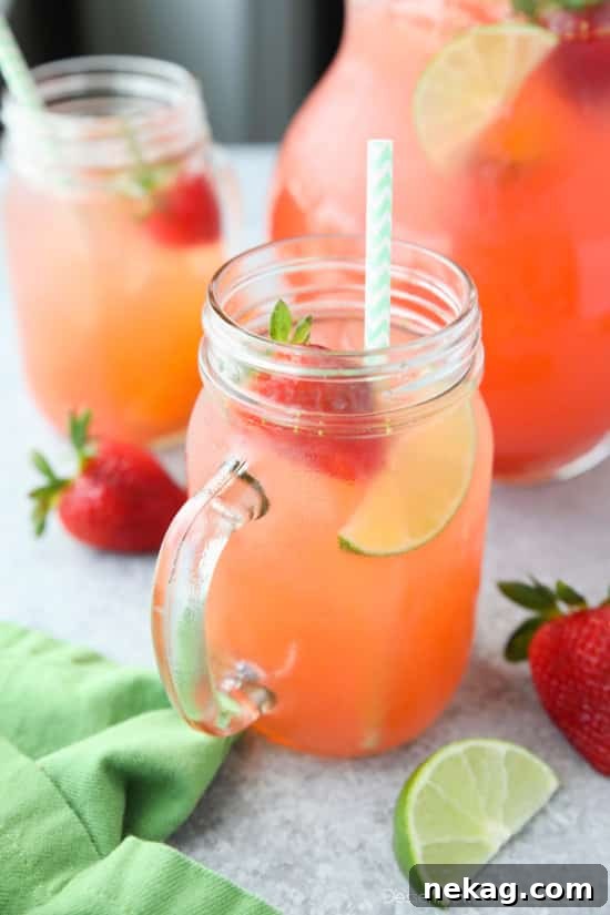 Blending fresh strawberries for Agua Fresca, a key step in creating this smooth fruit water.