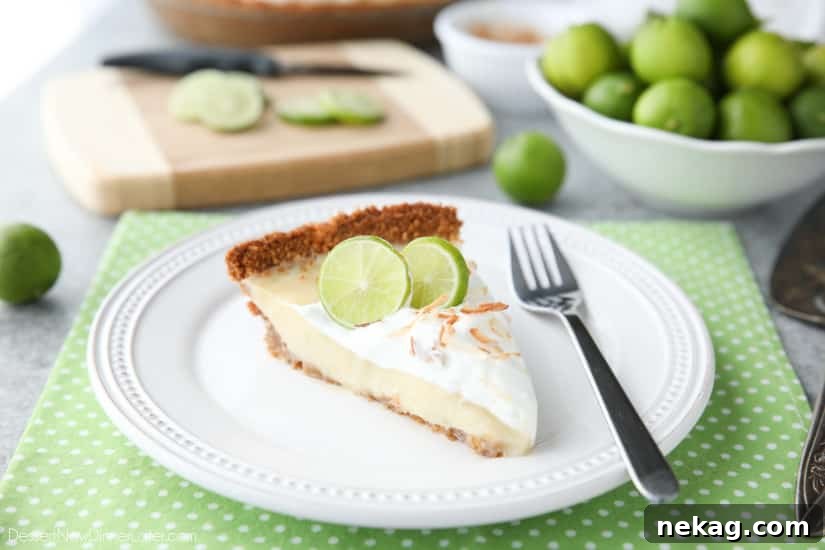 Coconut Key Lime Pie has coconut in the crust, cream of coconut in the key lime filling, and toasted coconut on top! A tropical dessert that's creamy, sweet, and tart.