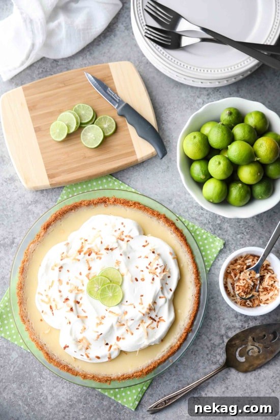 Coconut Key Lime Pie has coconut in the crust, cream of coconut in the key lime filling, and toasted coconut on top! A tropical dessert that's creamy, sweet, and tart.