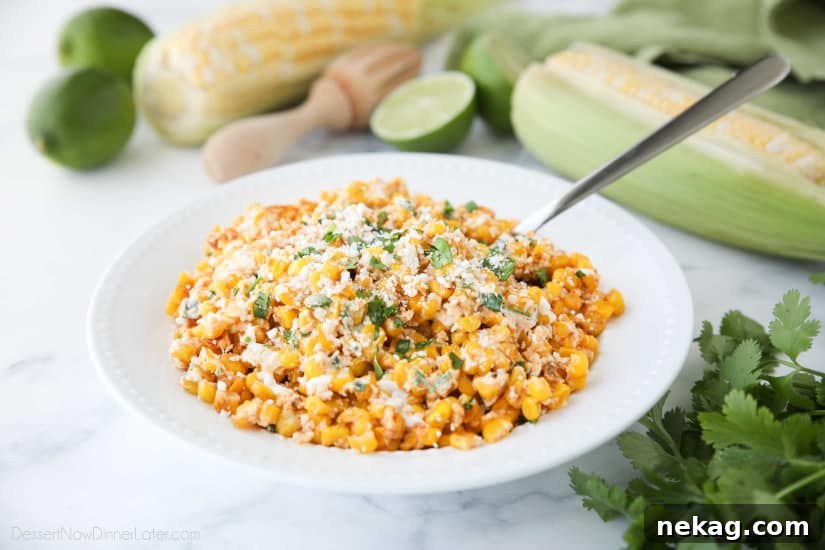 Close-up of a bowl of Mexican Street Corn Salad, highlighting the creamy texture and colorful ingredients like corn, cheese, and cilantro.