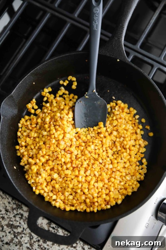Charred corn kernels in a cast iron skillet, ready to be turned into Mexican Street Corn Salad.