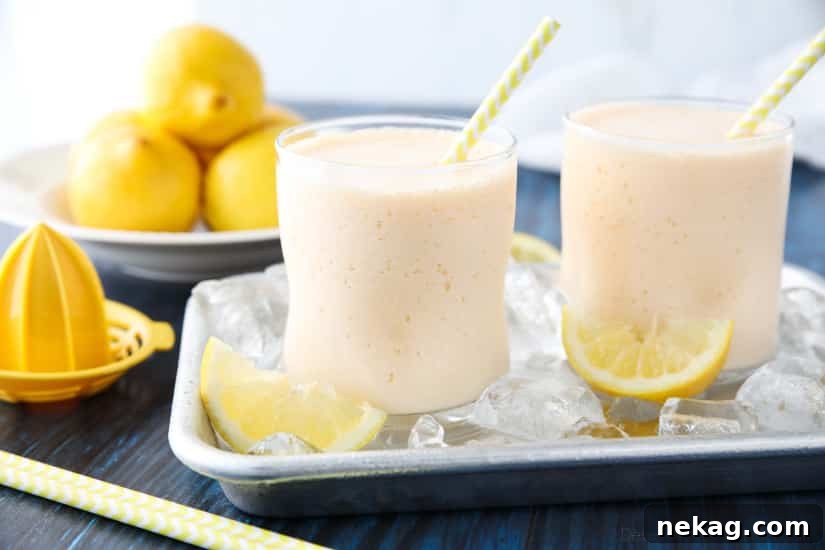 A close-up of the frosted lemonade mixture swirling in a blender, showing its thick, uniform consistency before being poured into glasses.