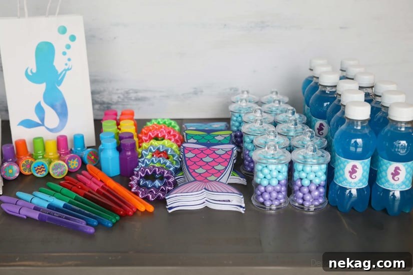 Magical Mermaid Tail Pull Apart Cupcakes 14 Assortment of mermaid party favors, including customized bags, pens, stampers, bubbles, bracelets, and mermaid tail notebooks.