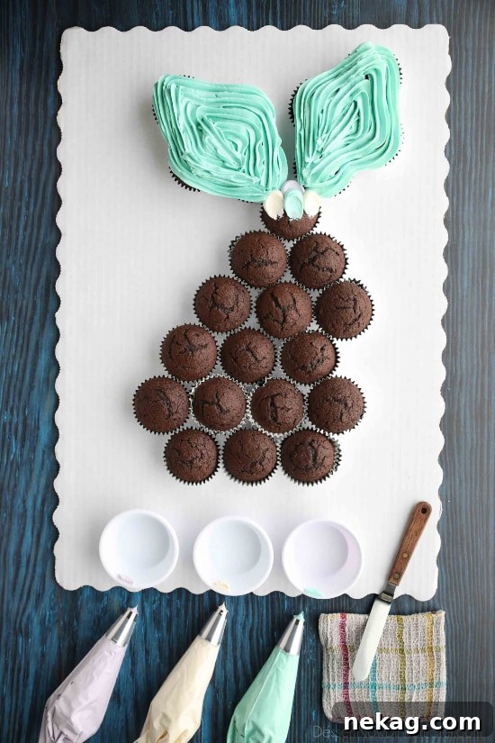 Magical Mermaid Tail Pull Apart Cupcakes 5 Essential tools for piping mermaid tail scales: multiple piping bags with different colored frostings and round tips, a small offset spatula, and a damp washcloth for cleaning.