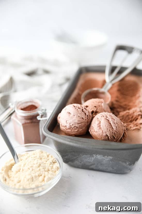 Malted Chocolate Dream 4 Three scoops of homemade chocolate malt ice cream with a spoon, ready to be enjoyed.
