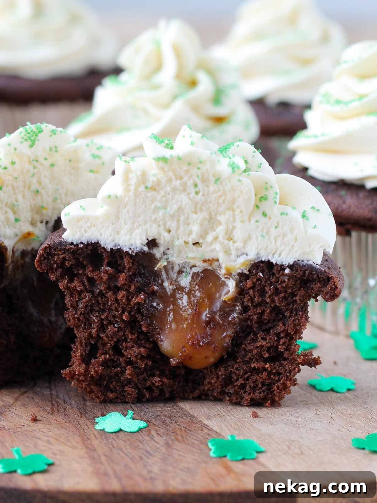 A cupcake sliced open to reveal caramel filling inside.