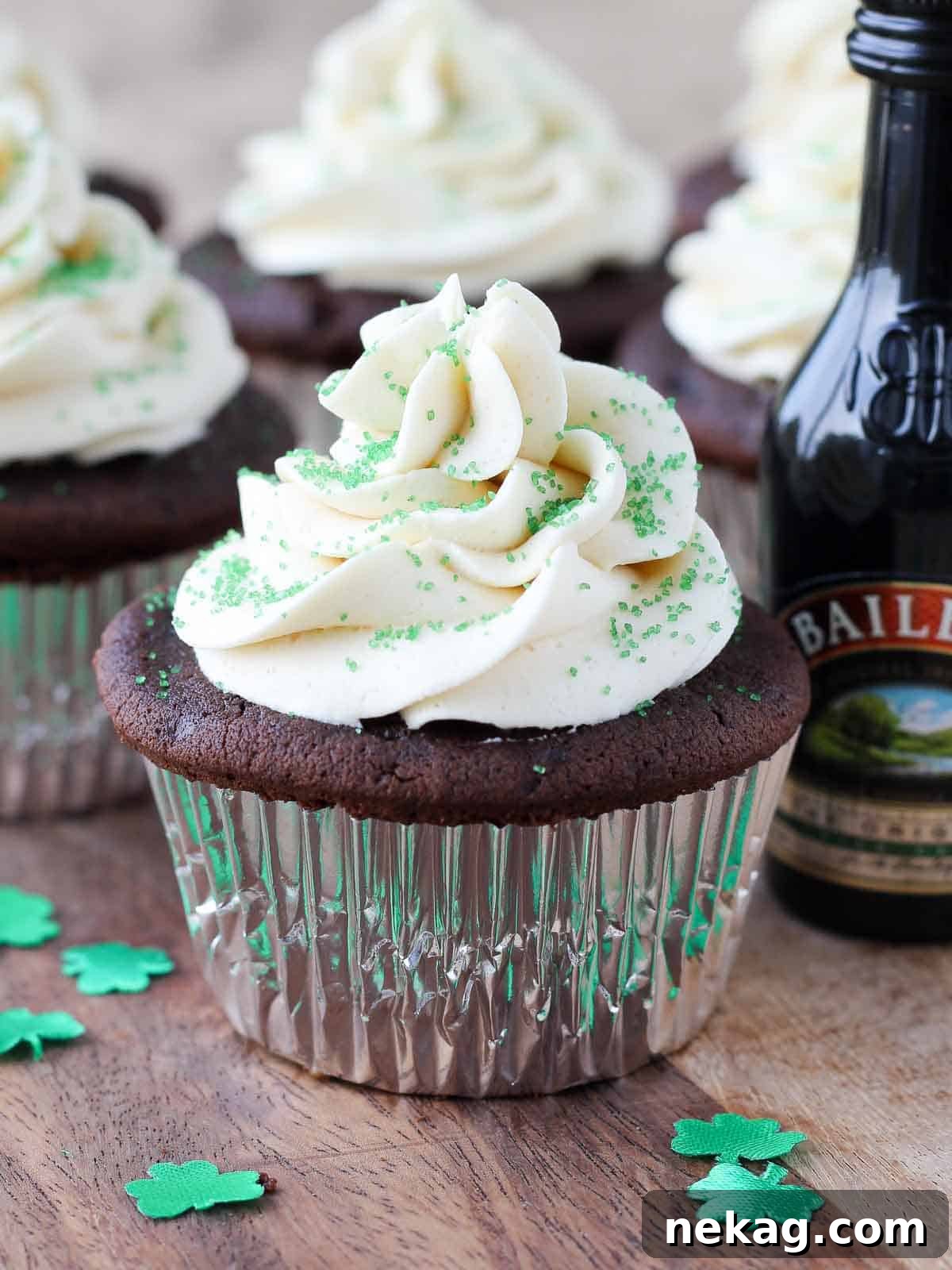 chocolate cupcakes top with green sprinkles.
