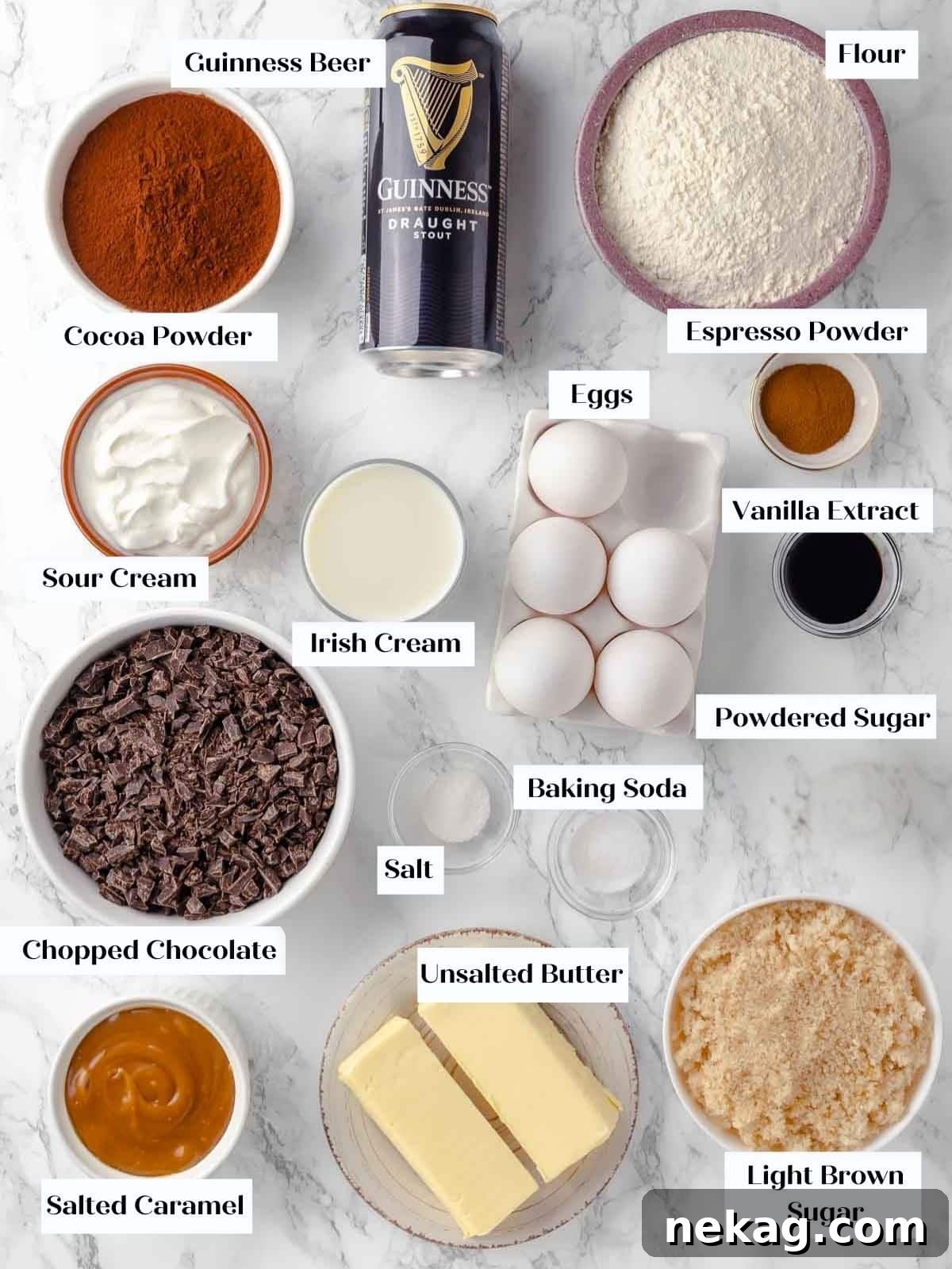 Cupcake ingredients laid out on a white marble counter.