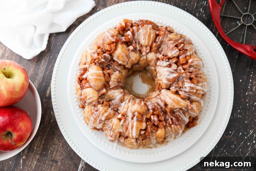 Apple Fritter Monkey Bread is an easy and delicious pull apart bread with chunks of caramelized apples, sticky cinnamon-sugar, and a light glaze. Fashioned after your favorite donut, this apple fritter bread makes a tasty breakfast or dessert.