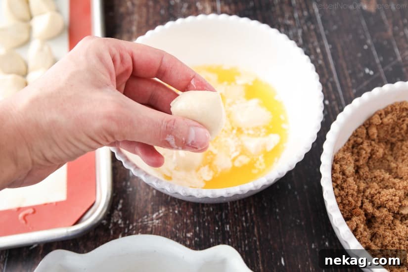 Apple Fritter Monkey Bread - Coating the dough pieces with melted butter.