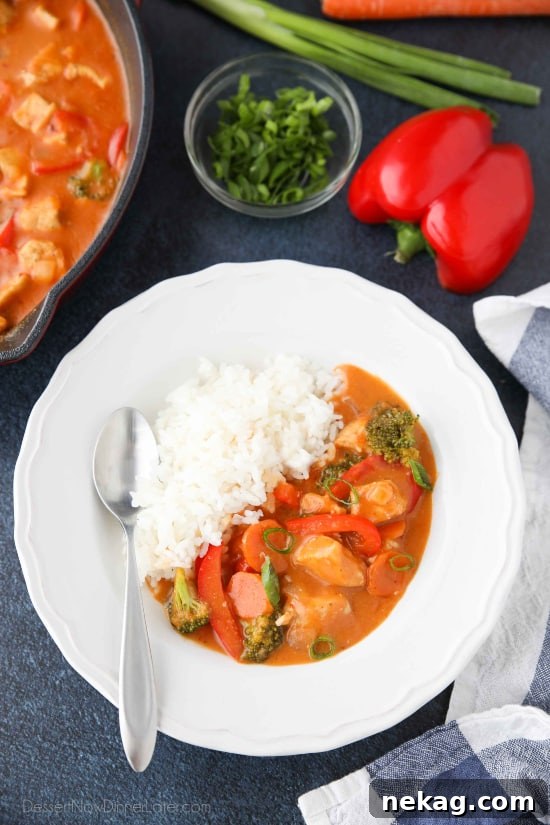 Vibrant Thai Red Curry 5 A selection of fresh ingredients for Thai Red Curry laid out on a cutting board, including chicken, various vegetables, and spices.