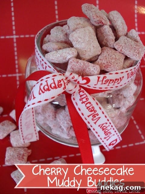 A vibrant pink image of Cherry Cheesecake Muddy Buddies in a bowl, ready to be enjoyed.