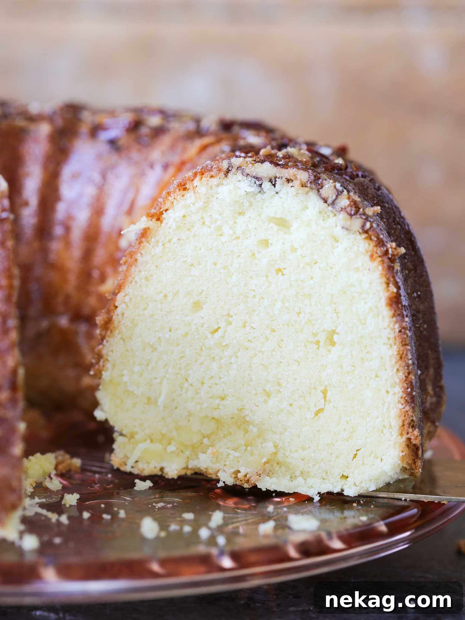 Spirited Bacardi Delight 2 Bacardi Rum Cake sliced, viewed from the side, showcasing its moist texture and rich glaze.