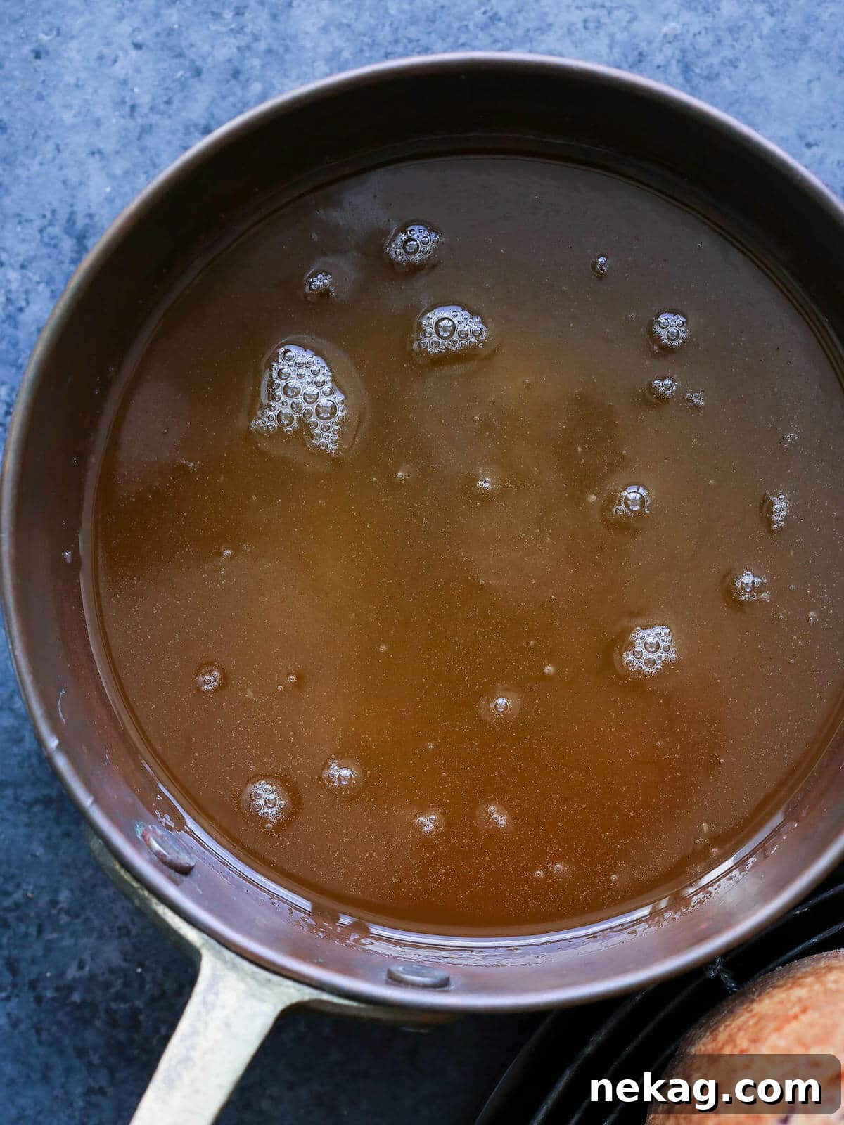 Spirited Bacardi Delight 6 Buttery rum glaze for cake simmering in a copper pot, ready to be poured.