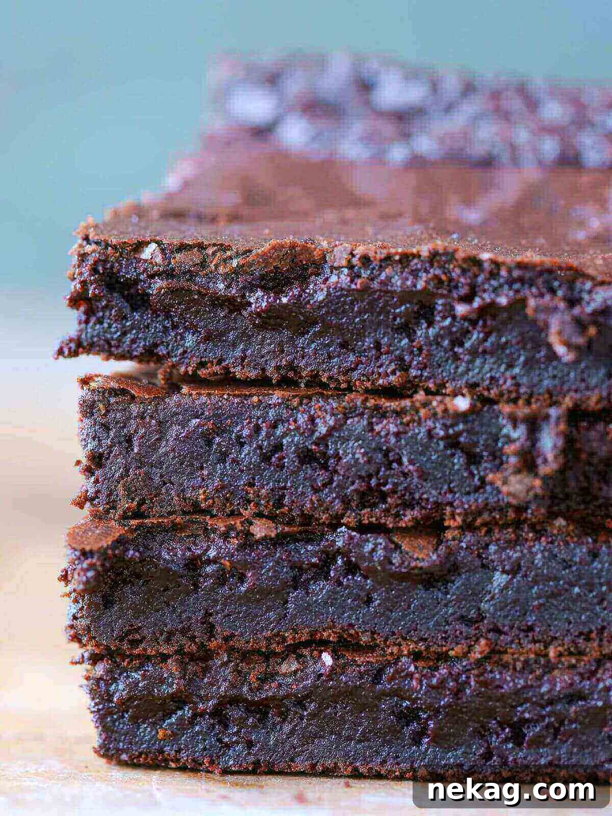 Lazy Day Brownies 2 A stack of delicious one-bowl brownies with a flaky top, ready to be enjoyed.