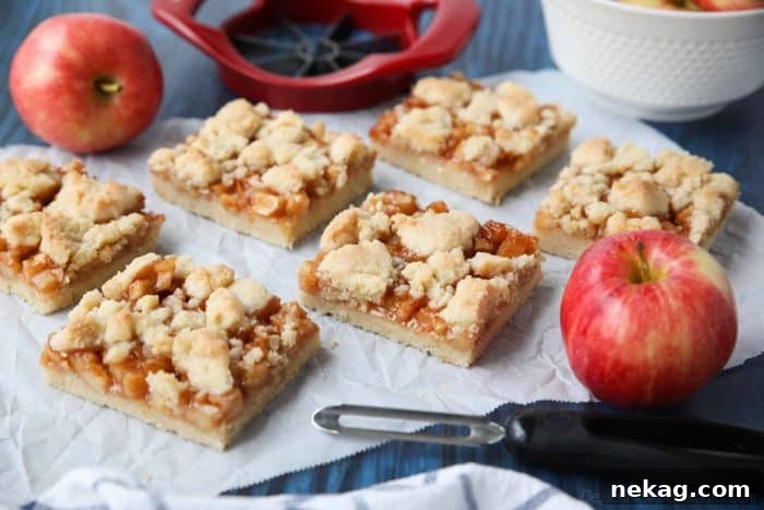 Sweet Apple Crumble Bars 4 Freshly baked Apple Crumb Bars arranged on a baking sheet, ready for serving, highlighting their golden crust and appealing texture.
