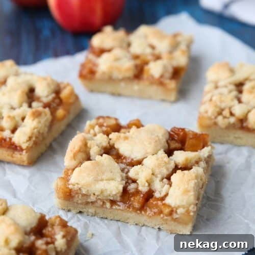 Apple Crumb Bars with a golden crust and bubbly apple filling, presented beautifully.