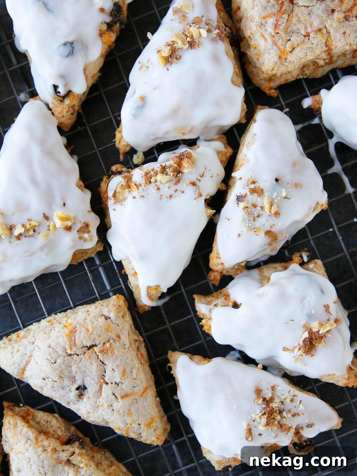 Spiced Carrot Cake Scones 2 A batch of golden-brown carrot cake scones ready to serve, glistening with cream cheese glaze.