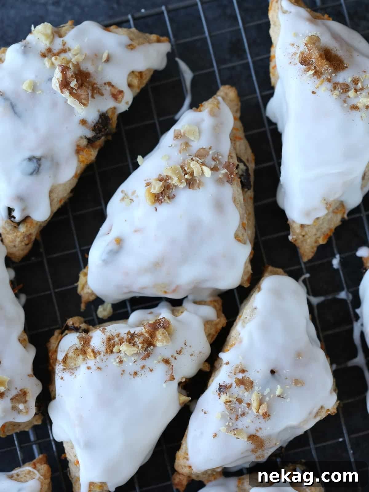 Spiced Carrot Cake Scones 5 Carrot cake scones beautifully sprinkled with chopped walnuts on top of the glaze.