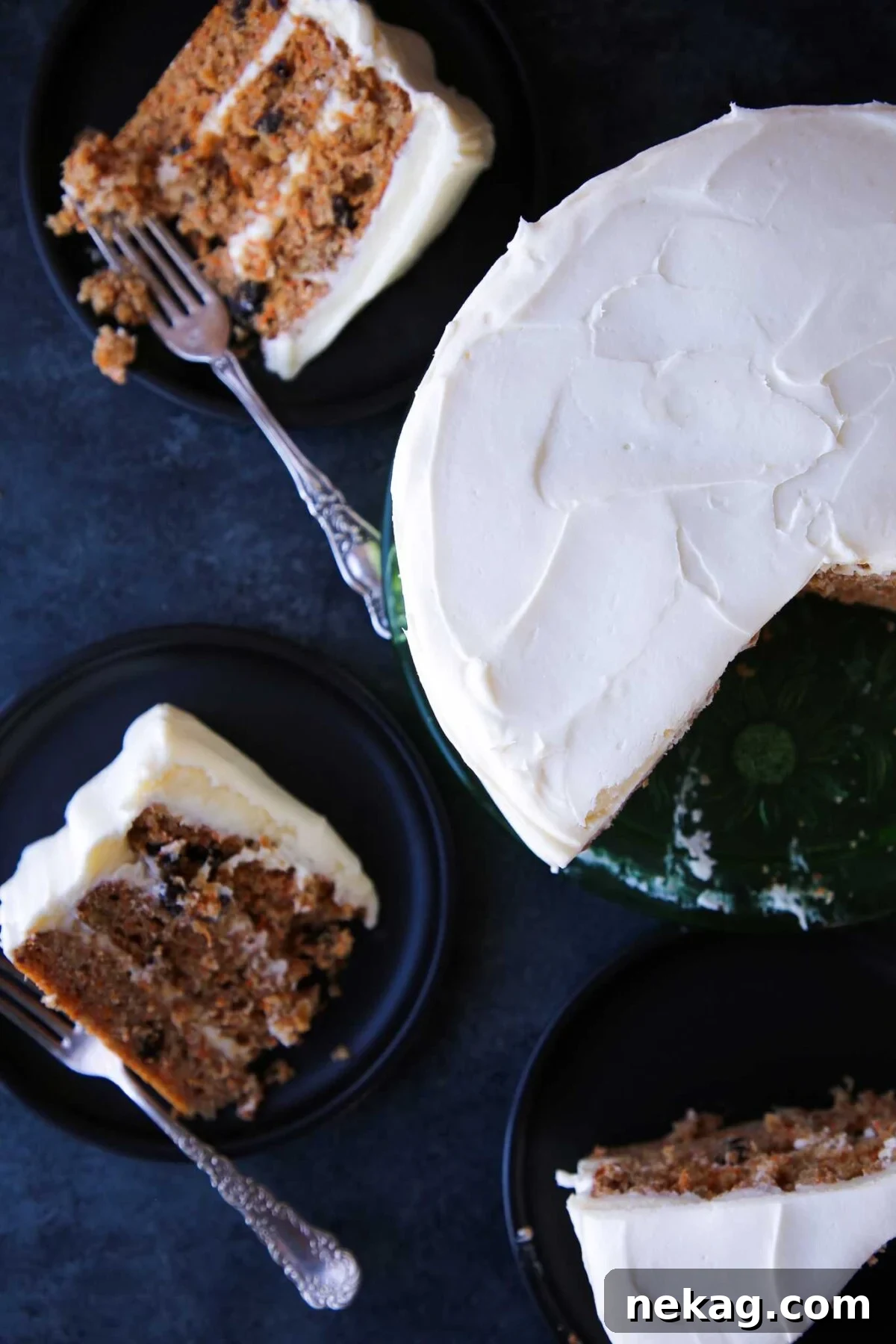 A perfectly sliced piece of easy carrot cake resting on a counter, showing layers of cake and frosting.