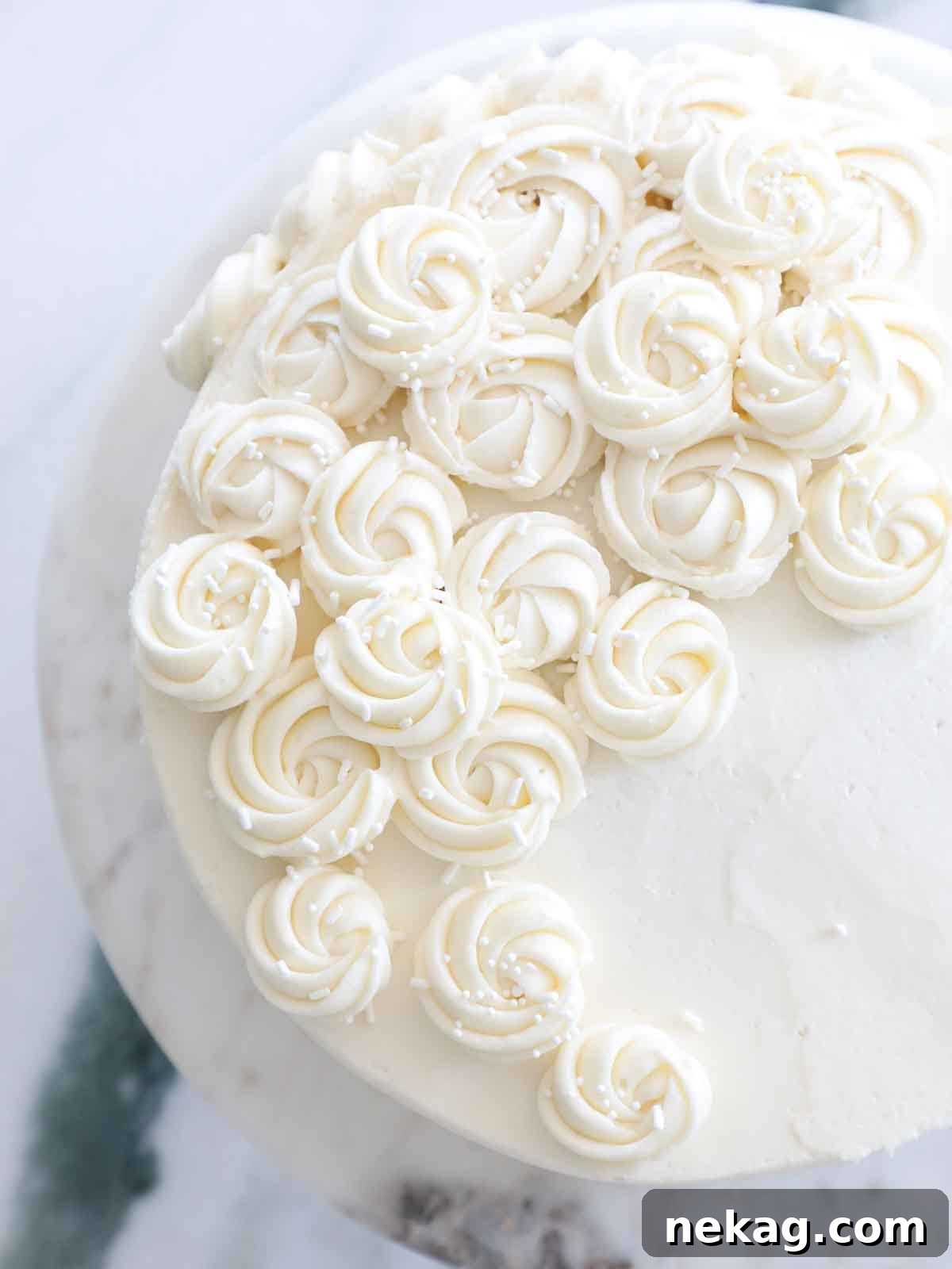 Vanilla American buttercream piped into elegant rosettes on a beautifully decorated cake, showcasing its smooth texture and perfect hold.