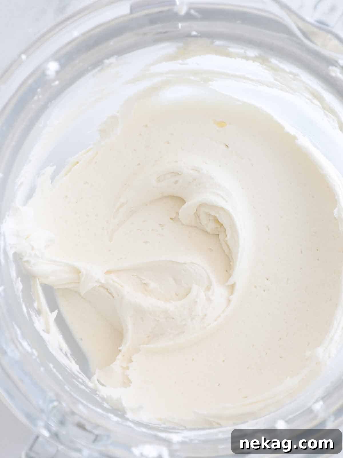 Smooth and perfectly whipped vanilla American buttercream in a stainless steel mixing bowl, ready for frosting.
