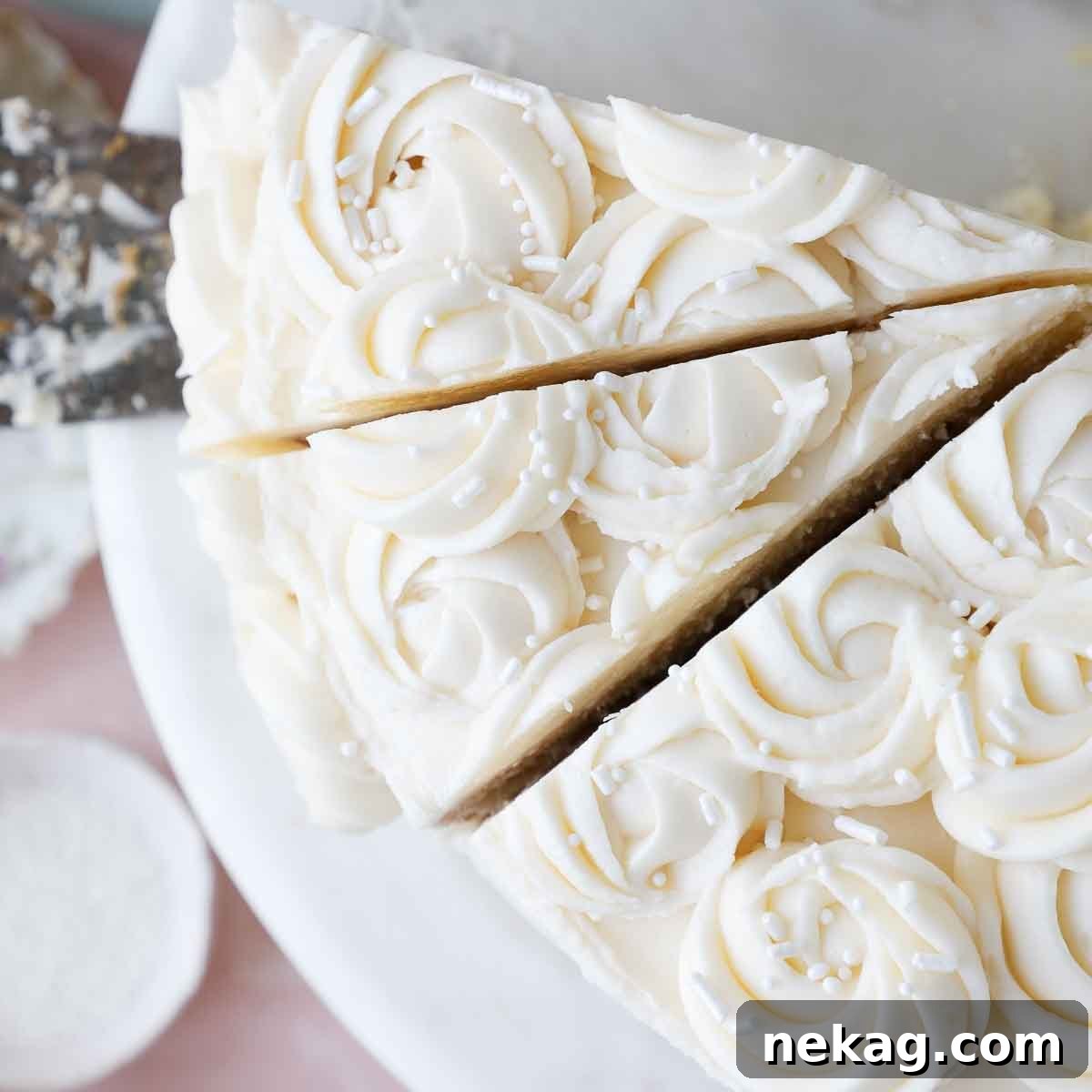Slices of moist vanilla cake generously frosted with smooth American buttercream, ready to be enjoyed.