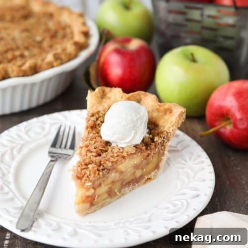 A whole Dutch Apple Pie with a golden crumb topping and a delicious filling, ready to be sliced and served.