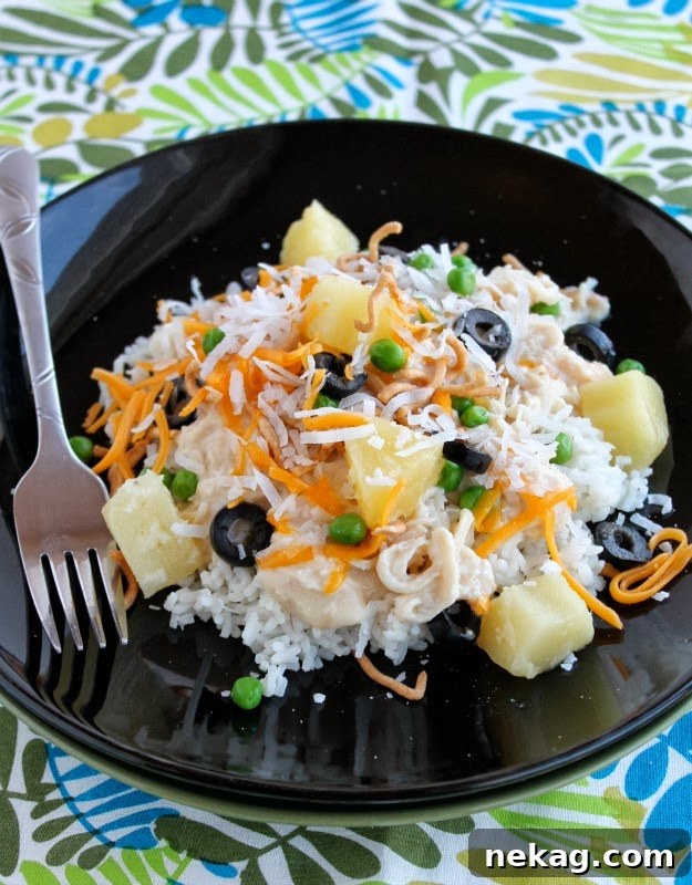 Hawaiian Stack Bowls 2 A vibrant Hawaiian Haystacks meal featuring a creamy chicken base over rice with various colorful toppings, appealing and ready to be customized.