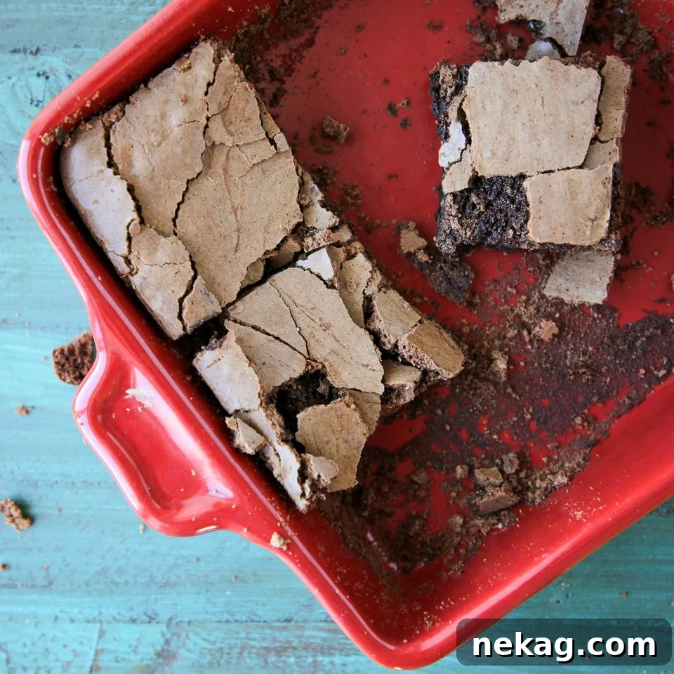 Nutty Brown Butter Brownies 4 A vibrant red baking dish filled with freshly baked Brown Butter Brownies, showcasing their rich color and inviting texture.