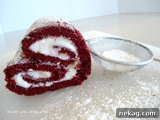Velvet Love Bites 3 A close-up shot of a single slice of Red Velvet Cake Heart, revealing the vibrant red cake and creamy white frosting swirl.