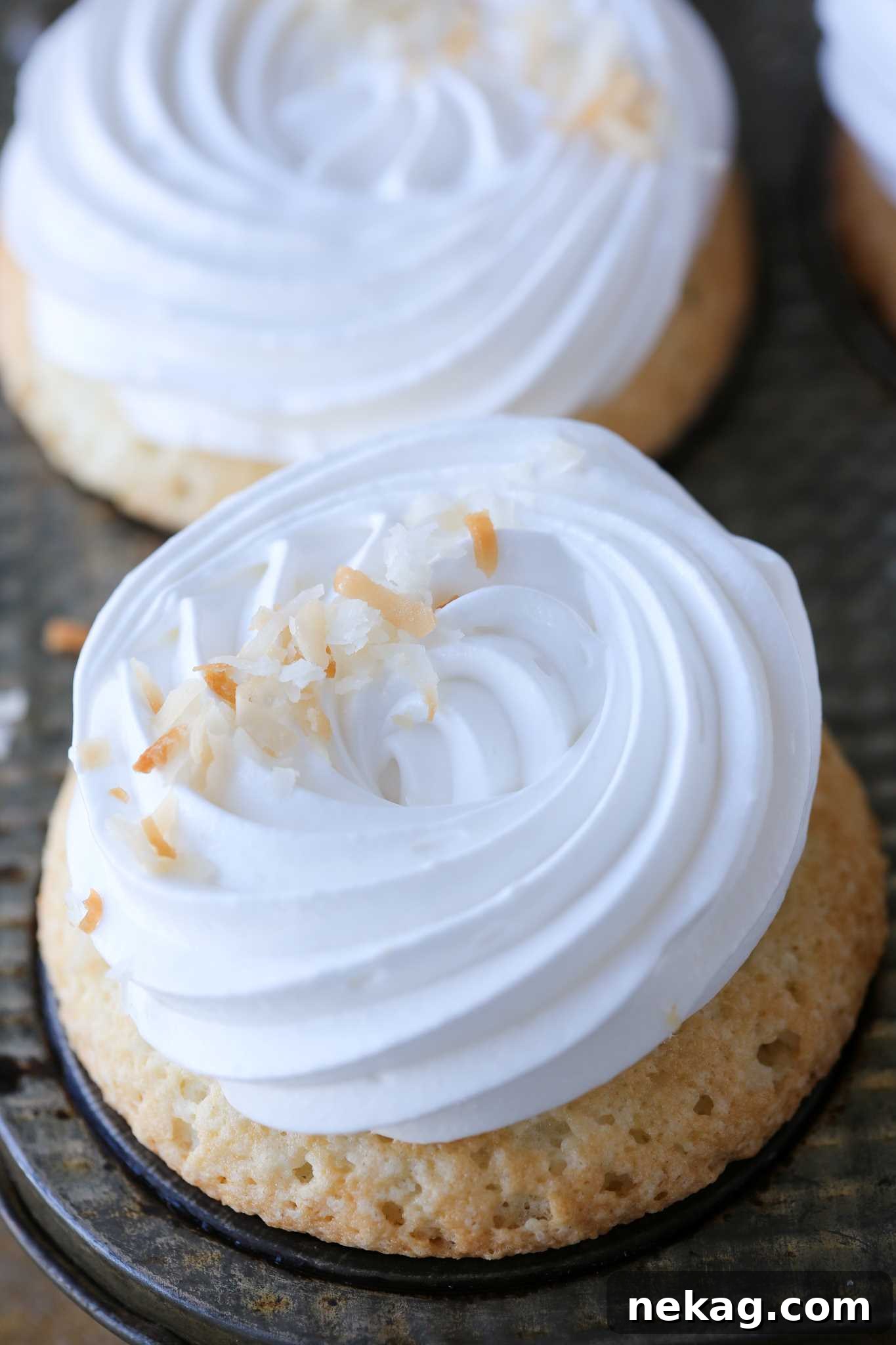 Fluff expertly piped onto delicate cupcakes, ready for serving.