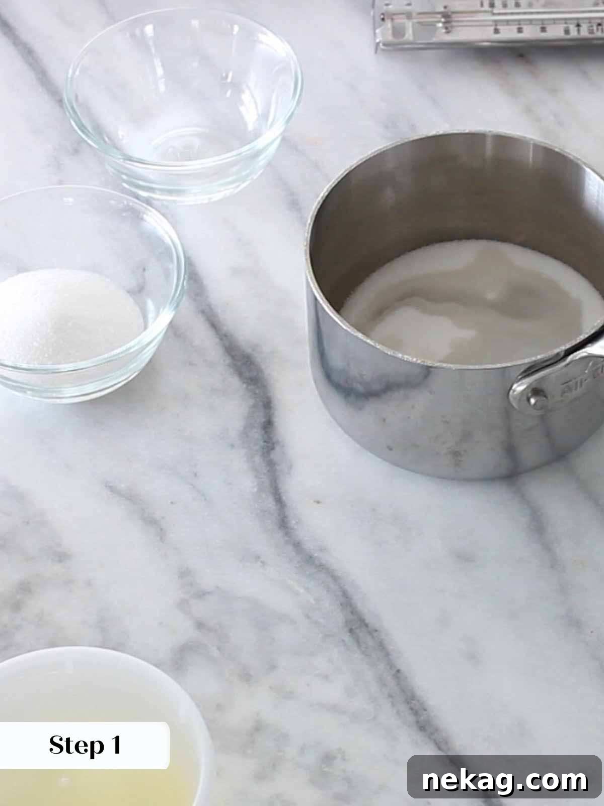 Preparing the sugar syrup for Italian meringue, with a candy thermometer in place.