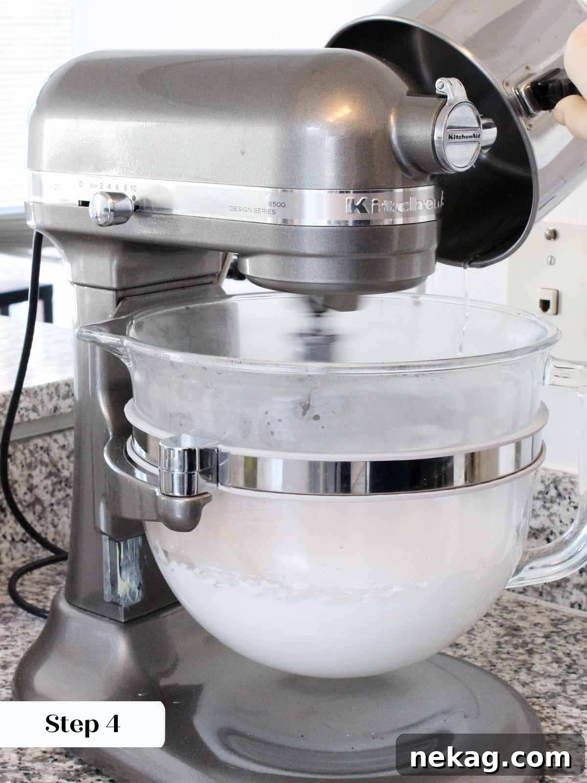 Slowly pouring hot sugar syrup into whipping egg whites for Italian meringue.
