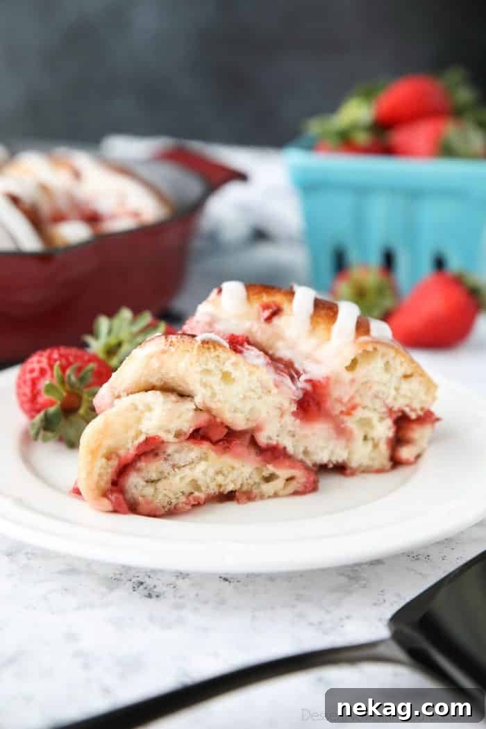Strawberry Swirl Bread - An easy, semi-homemade recipe using frozen dough, layered with fresh strawberries and jam, baked until golden, and topped with icing. A twist on strawberry sweet rolls.