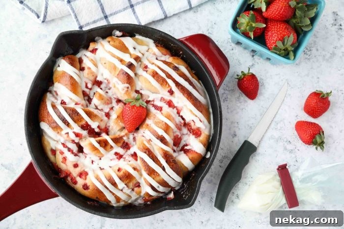 Strawberry Swirl Bread is made with frozen dough, strawberry jam, and fresh strawberries, then topped with a simple glaze.