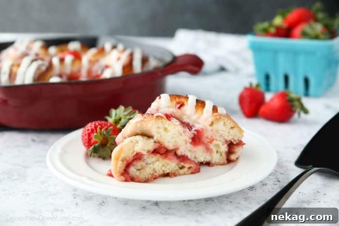 Strawberry Swirl Bread is a twist on classic sweet rolls. Sweet strawberry preserves and chunks of fresh strawberries are twisted inside of soft yeast bread, then baked until golden. Top it with a creamy icing and this easy sweet bread is perfect for breakfast or dessert.