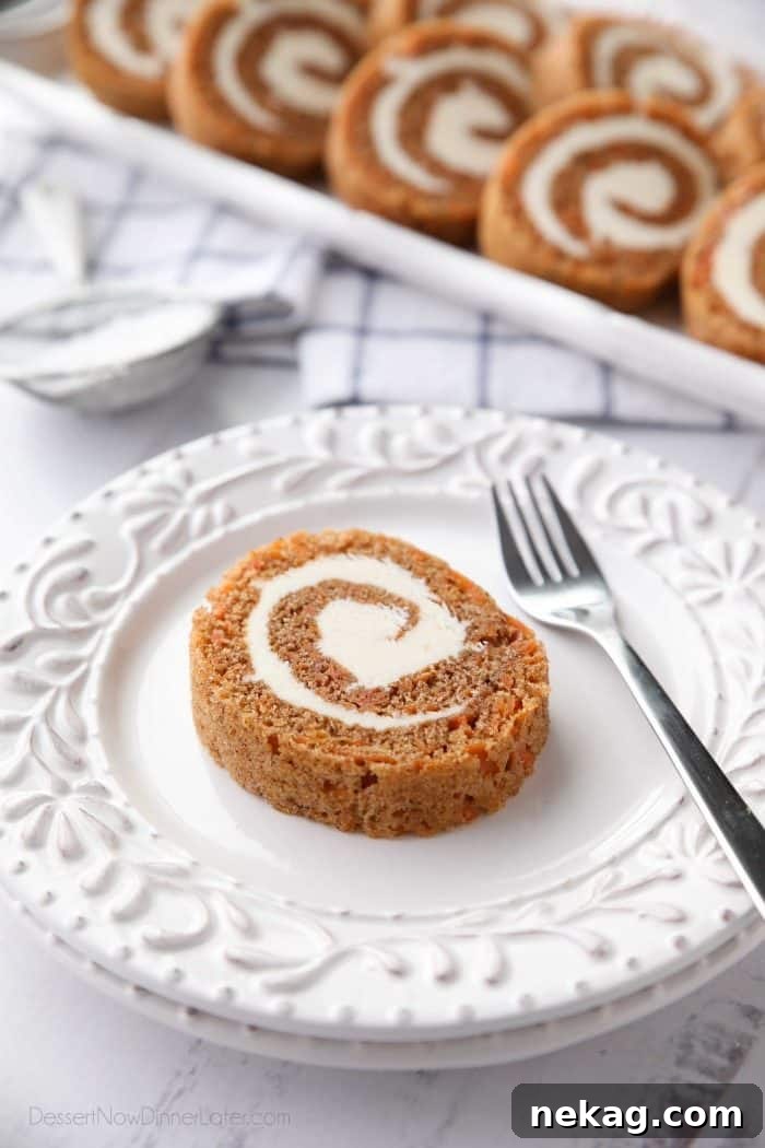 Sweet Swirls: Carrot Cake Roll Recipe 3 A perfectly sliced Carrot Cake Roll revealing layers of spiced cake and luscious cream cheese frosting.