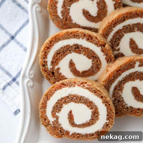 This Carrot Cake Roll is a classic Easter dessert with a twist. Spiced carrot cake is rolled up with the best cream cheese frosting inside. It's beautiful, delicious, and easy to make.