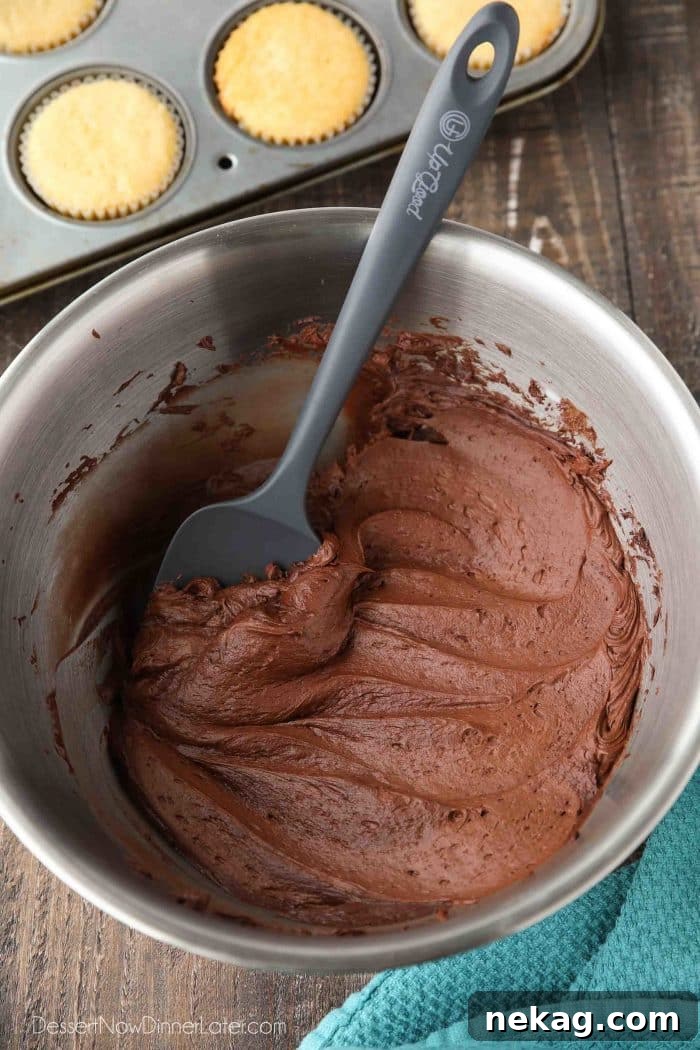 Close-up of classic chocolate frosting, highlighting its creamy, inviting texture, easy to achieve at home.