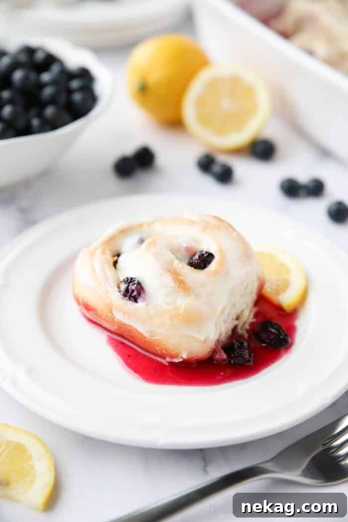Zesty Lemon Blueberry Buns 3 Gooey Lemon Blueberry Sweet Rolls with a vibrant blueberry sauce and zesty lemon cream cheese frosting, perfect for any occasion.