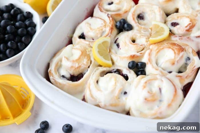 Zesty Lemon Blueberry Buns 7 Close-up of sweet and tangy Lemon Blueberry Rolls smothered in a thick, delicious lemon cream cheese frosting.
