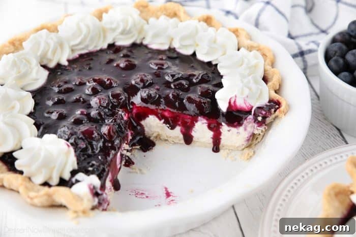 How to Make Perfect Blueberry Cream Cheese Pie 6 A Blueberry Cream Cheese Pie with two slices removed, revealing the creamy layers and rich blueberry topping, ready for serving.