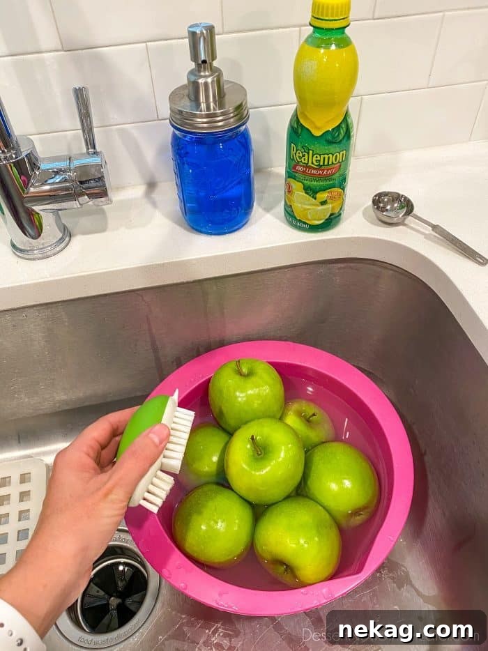 Handcrafted Caramel Apple Delights 3 To prevent caramel from sliding off apples, clean the wax off of apples before dipping in caramel. Soak apples in hot water with lemon juice (or vinegar), then use a produce brush with a little dish soap and scrub the apples well all around.