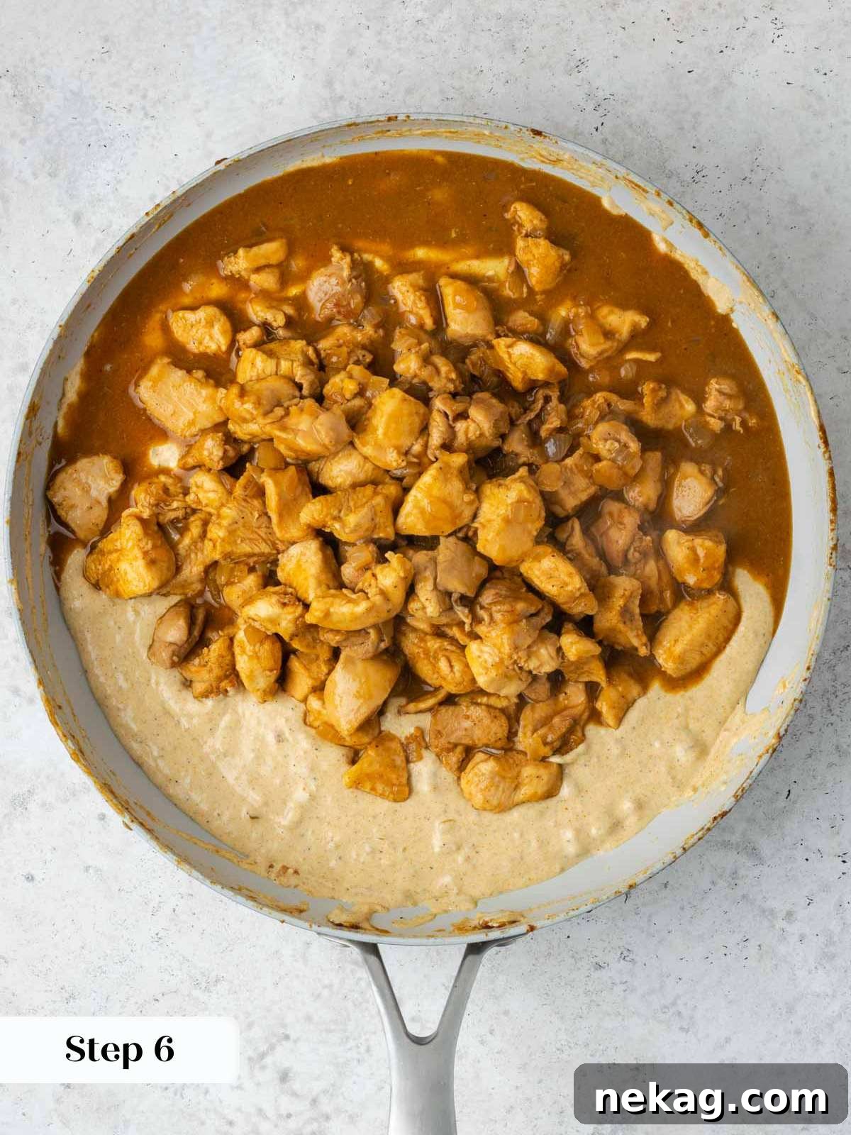 Classic Hungarian Chicken Paprikash 9 Thickened sauce with chicken in pan.
